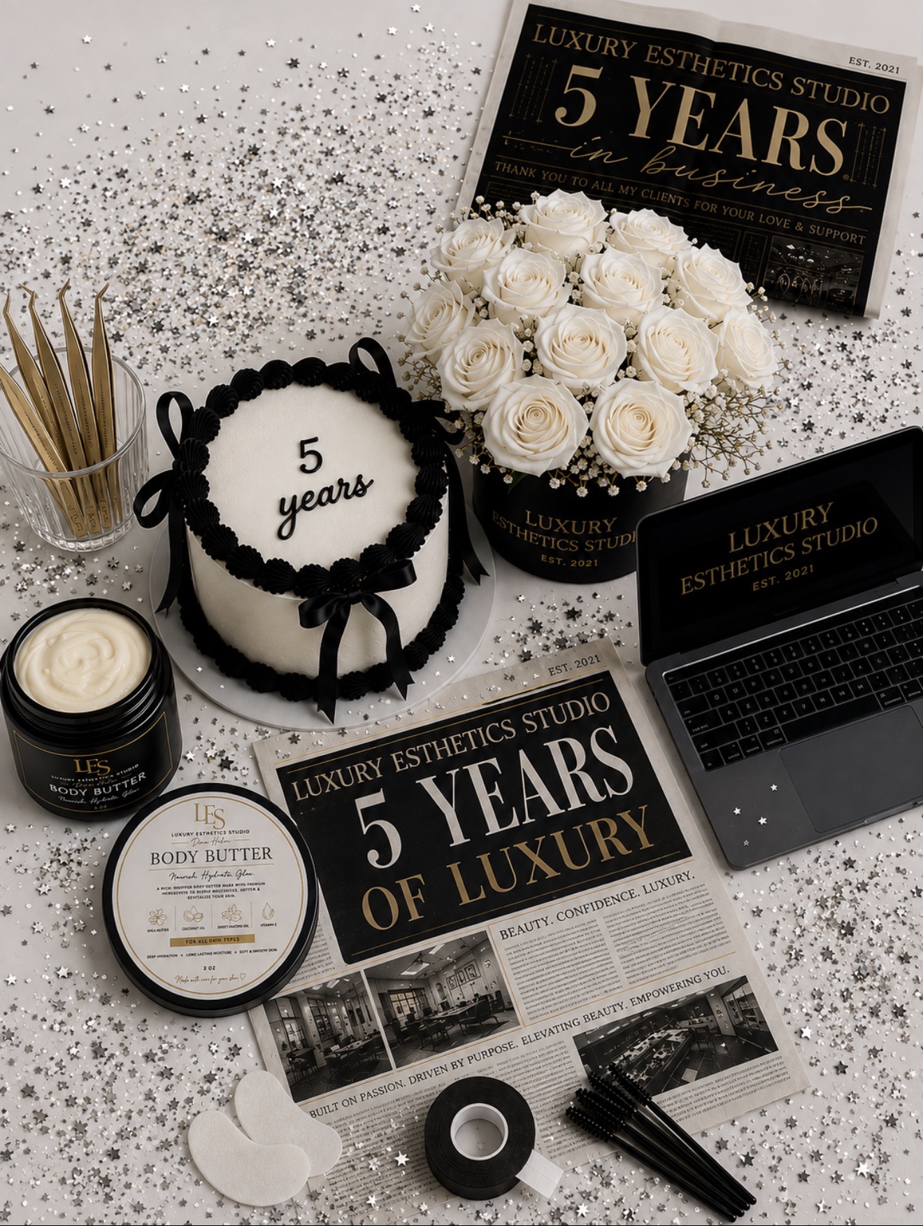 Celebration setup with a cake, flowers, candles, and promotional materials for five years of luxury esthetics studio.