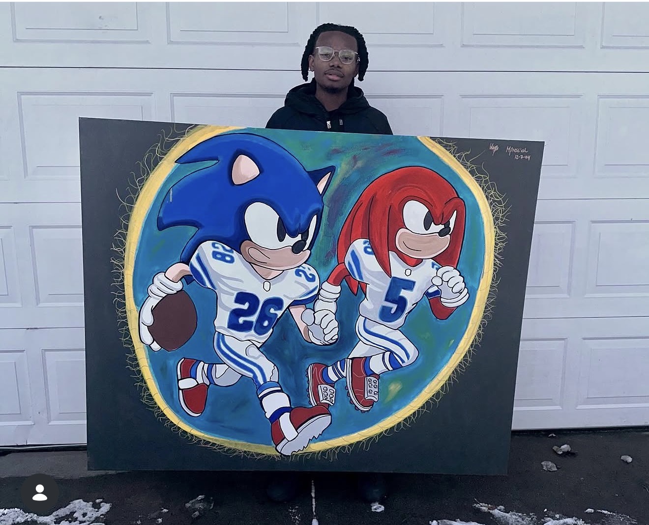Person holding a large painting of Sonic the Hedgehog and a red character in football uniforms, standing in front of a white garage door.