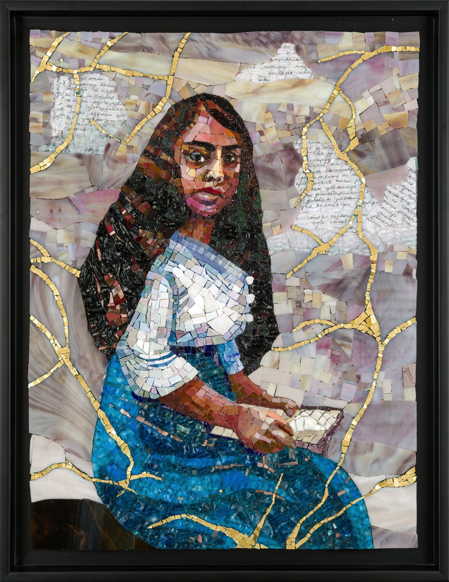 Portrait of a woman with long dark hair, wearing a white top and blue jeans, holding a book or paper.