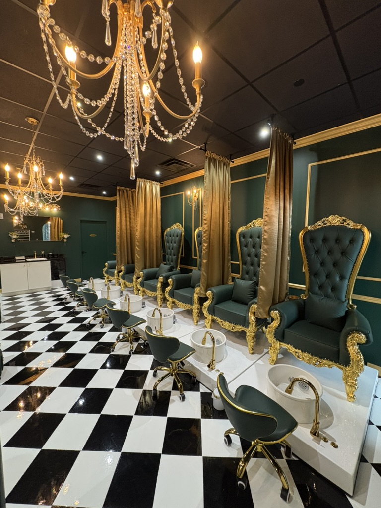 Luxurious room with chandeliers, gold curtains, and ornate blue chairs with gold accents, black and white checkered floor.