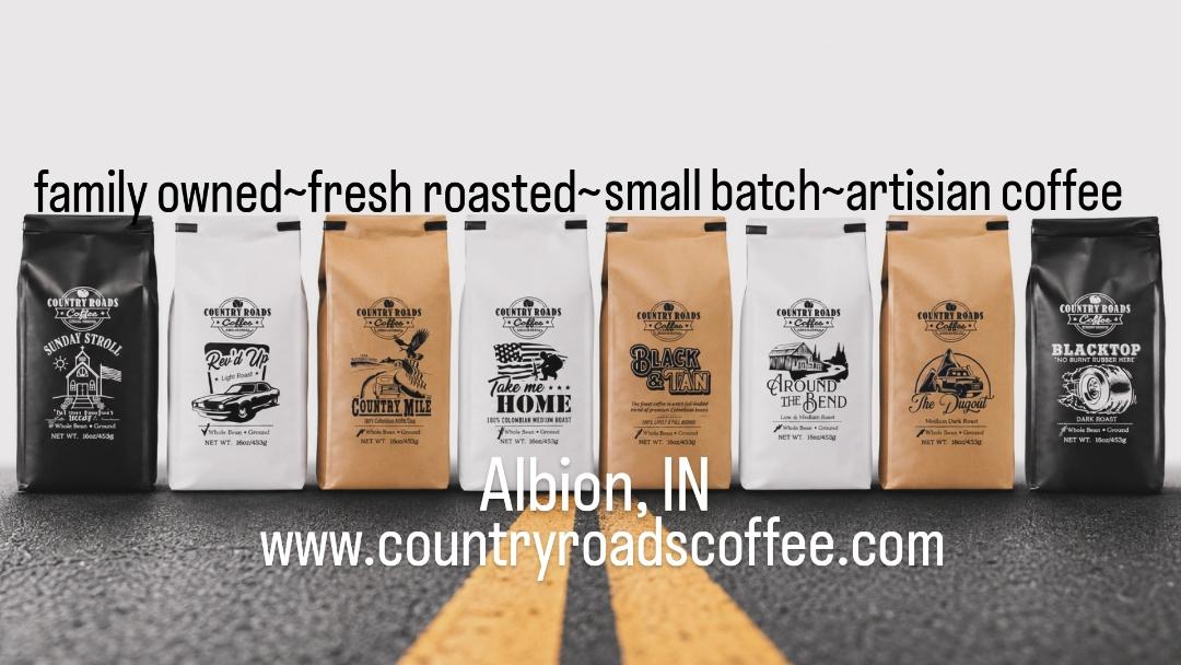Six coffee bags lined up on a road with yellow lines, text about coffee and website below, background is gray.