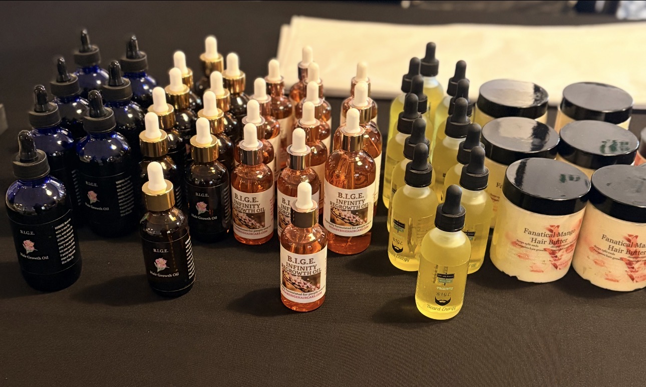 Assorted bottles and jars with droppers and labels arranged on a black surface.
