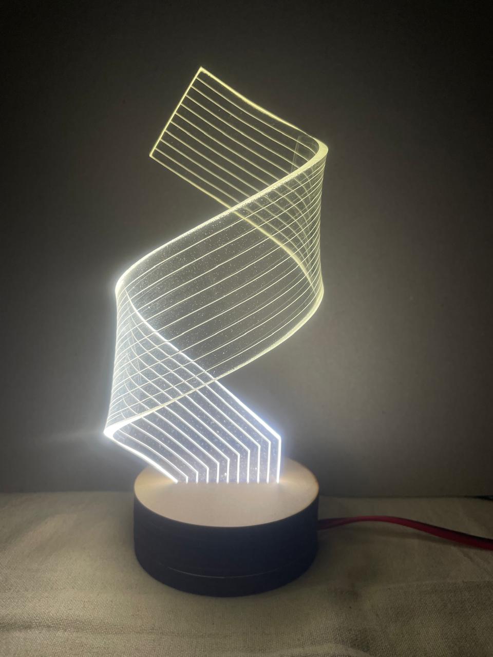 Light sculpture with a spiral wireframe design on a round base, glowing against a dark background.
