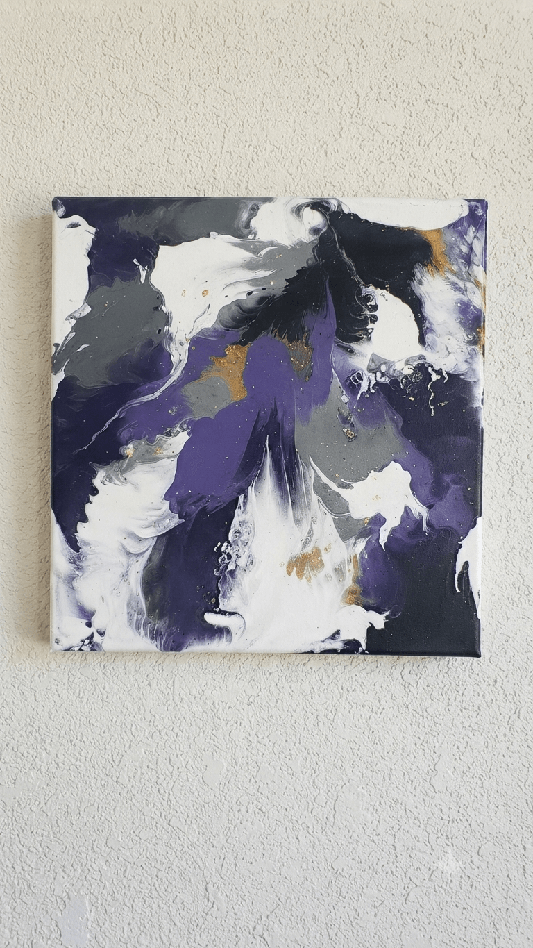 Abstract painting with purple, black, white, and gold colors on a canvas, hung on a light-colored wall.