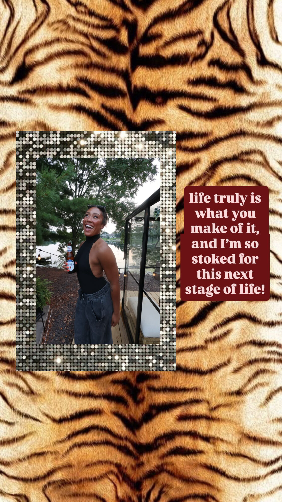 Person smiling outdoors, wearing a sleeveless top, standing near a railing with trees in the background, tiger print pattern.