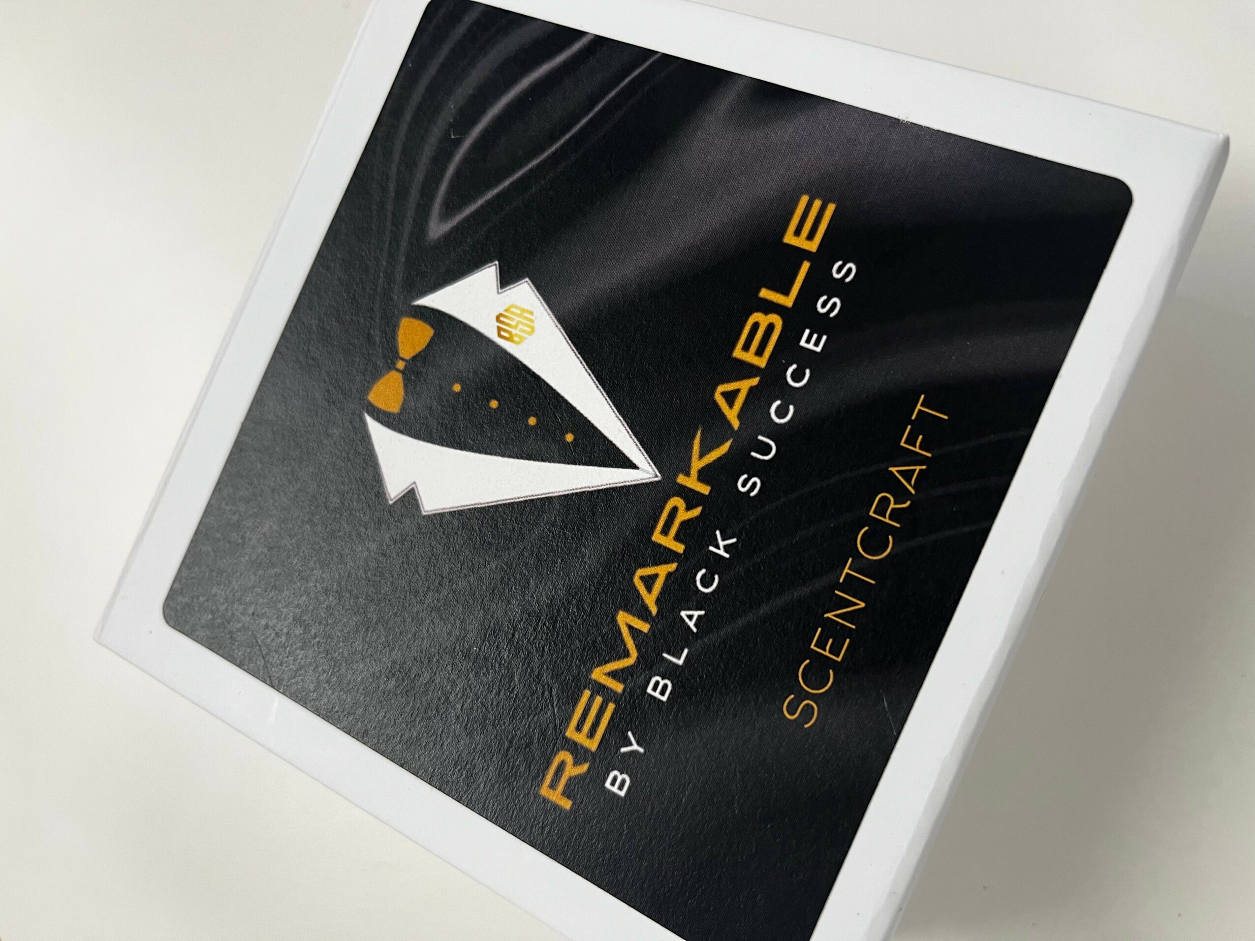 Book cover titled 'REMARKABLE' with black background and white and yellow text, placed on a white surface.