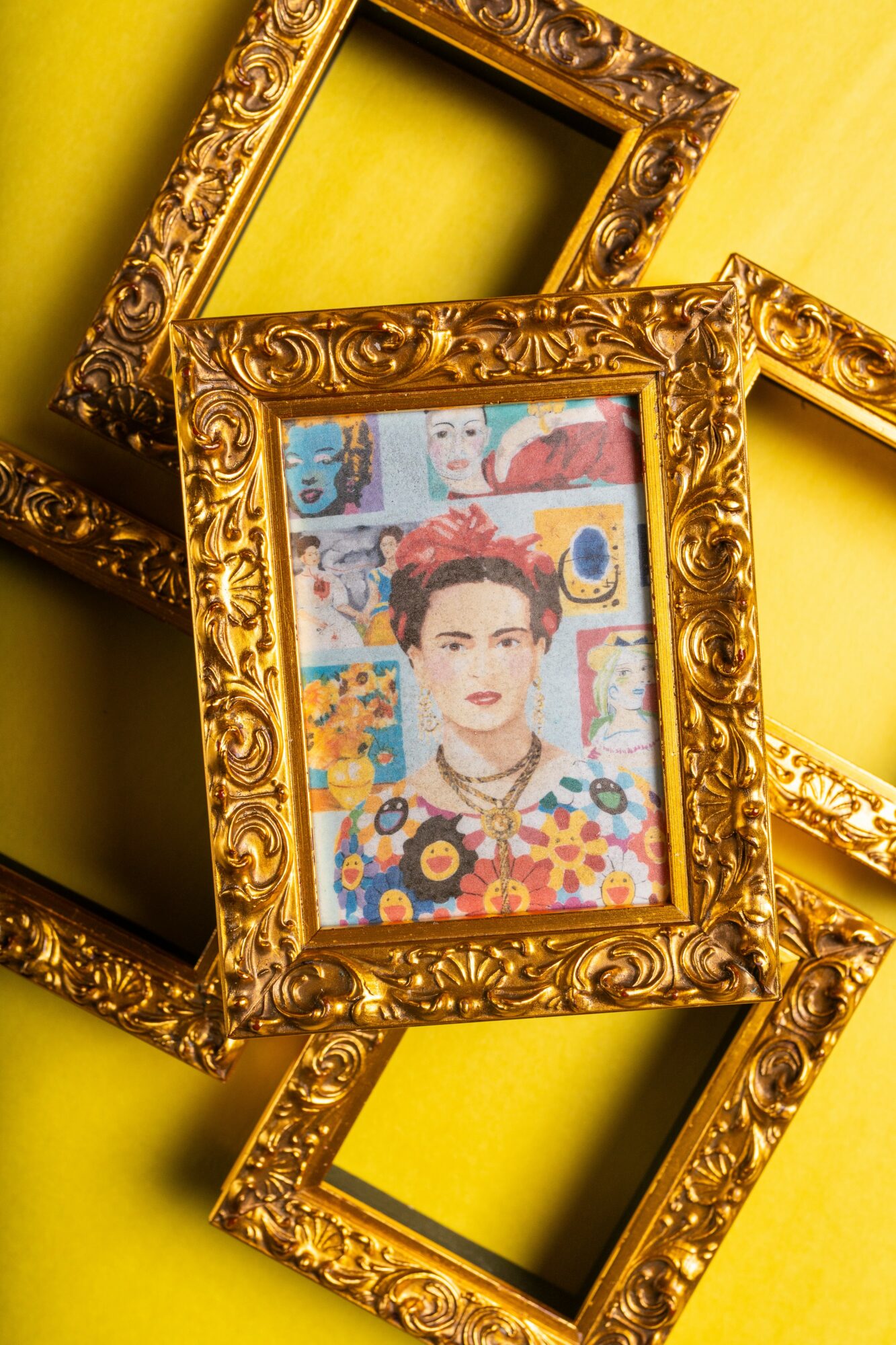 Colorful portrait of a woman with short hair, surrounded by vibrant artwork, in an ornate gold frame, on a yellow background.