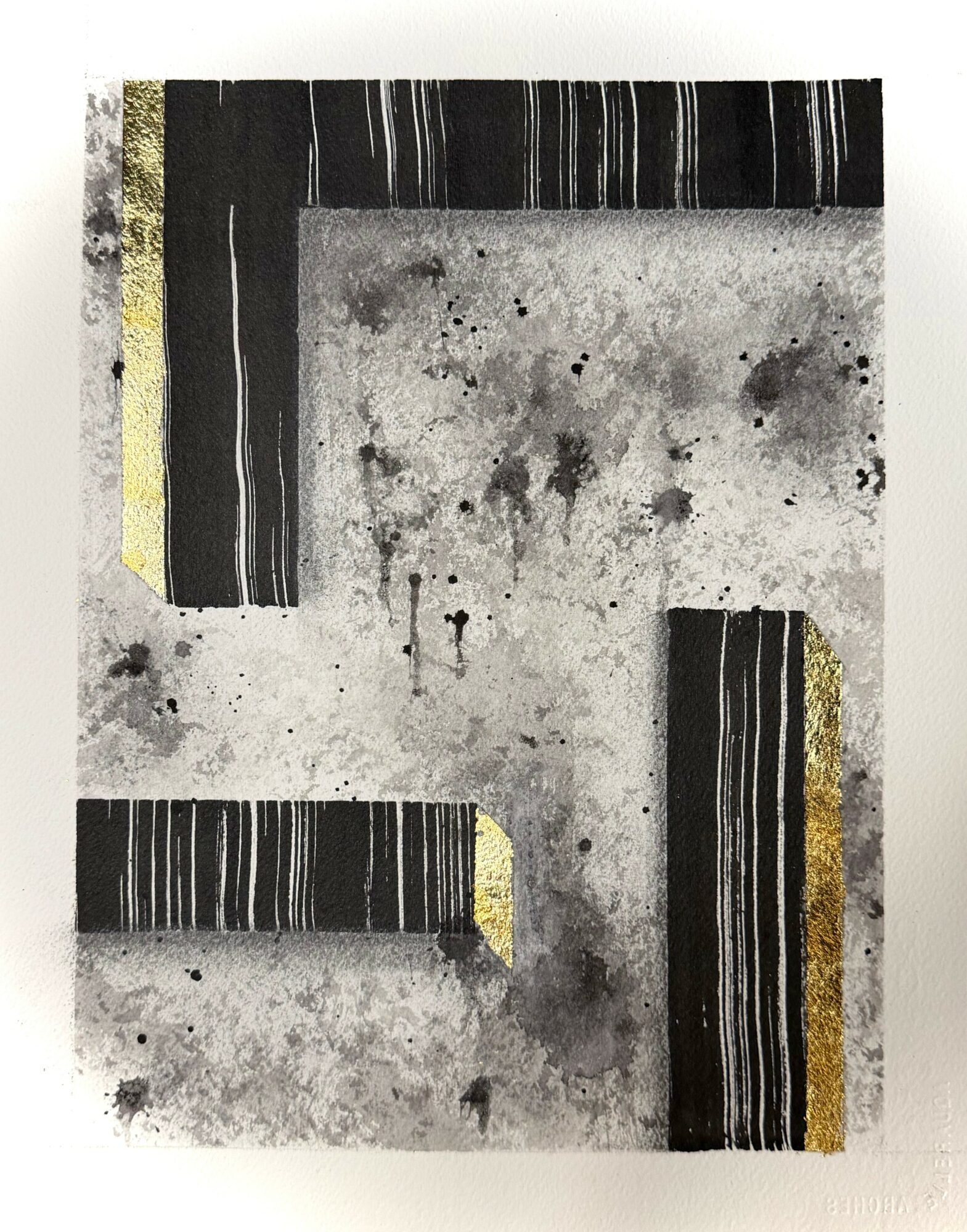 Concrete surface with black and gold striped blocks arranged in an L shape, some splatters and stains visible.