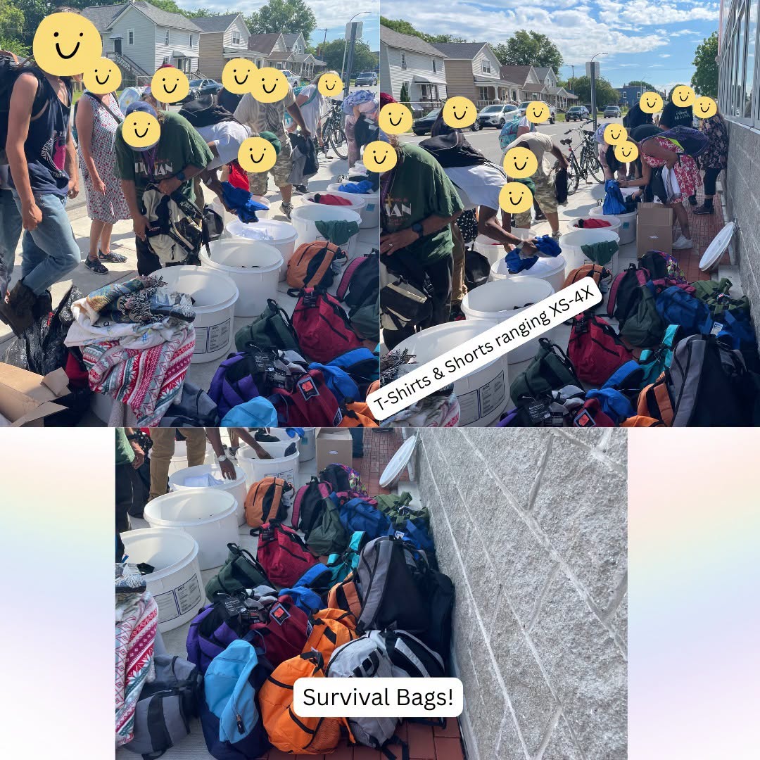 People with yellow smiley faces shopping for survival bags and T-shirts or shorts on a sunny street, with bags and supplies on the ground.
