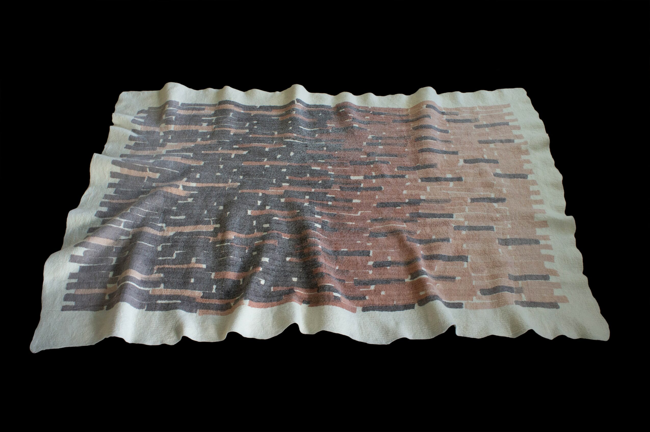 A crumpled piece of paper with a pixelated image of a brick wall and starry sky, on a black background.