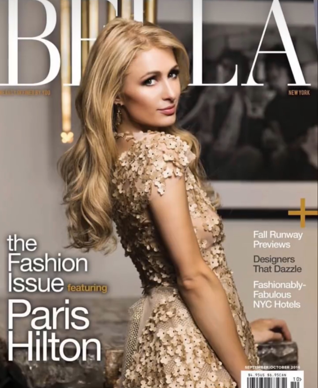 Woman with long blonde hair in a gold dress, looking over shoulder, in front of a blurred background.