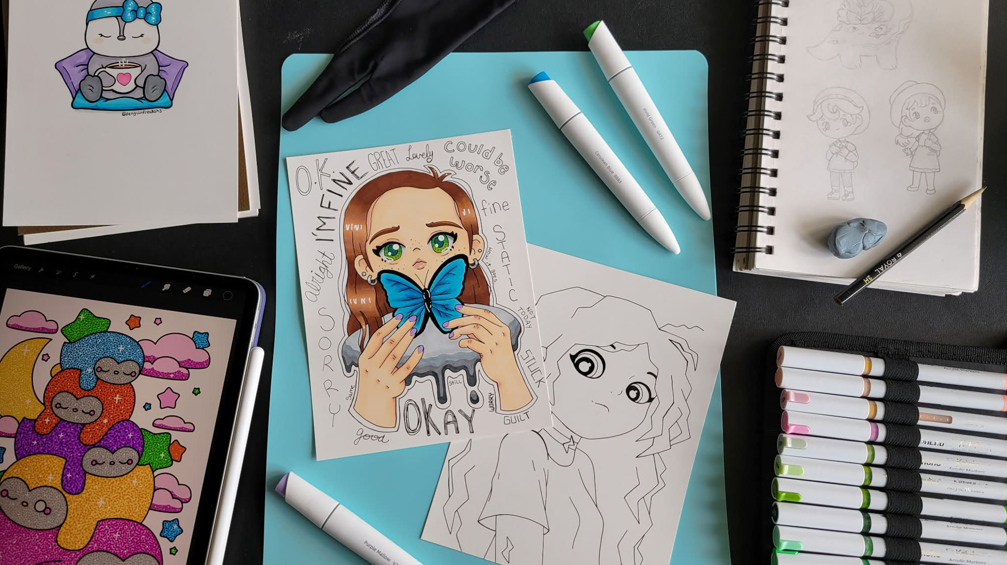 Art supplies including markers, sketches, and a drawing of a girl with a butterfly mask, on a black surface.