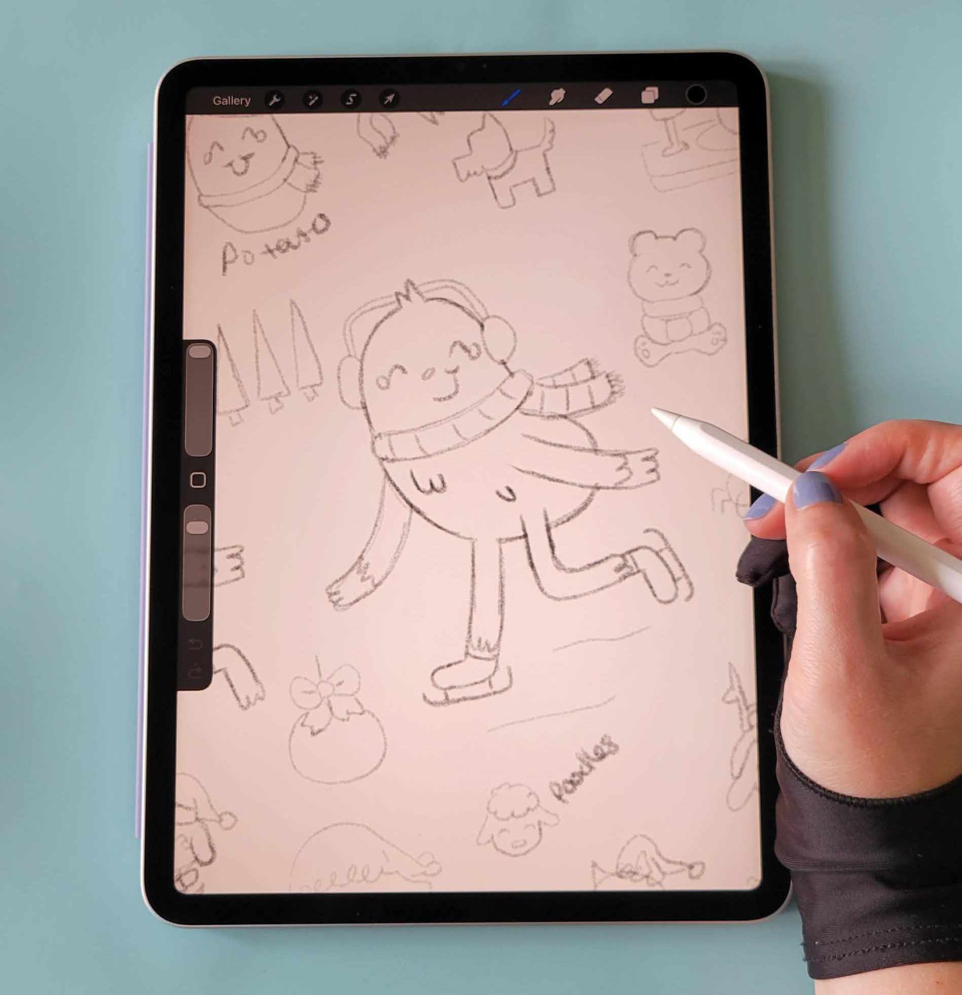 Person drawing a cartoon character on a tablet with a stylus, surrounded by various sketches of animals and objects.