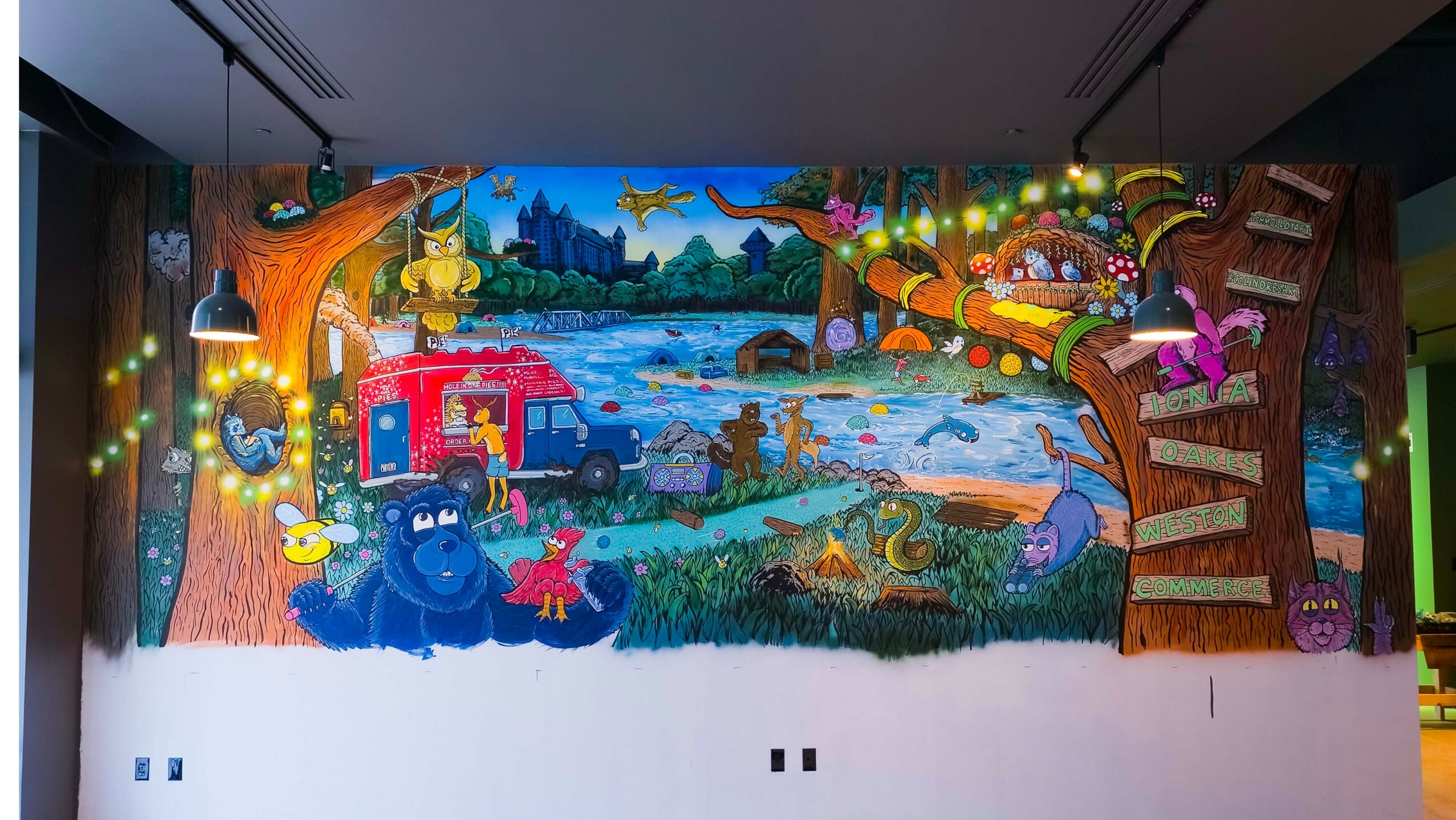 Colorful mural depicting a forest scene with animals, a river, and a treehouse, with glowing lights on the sides.