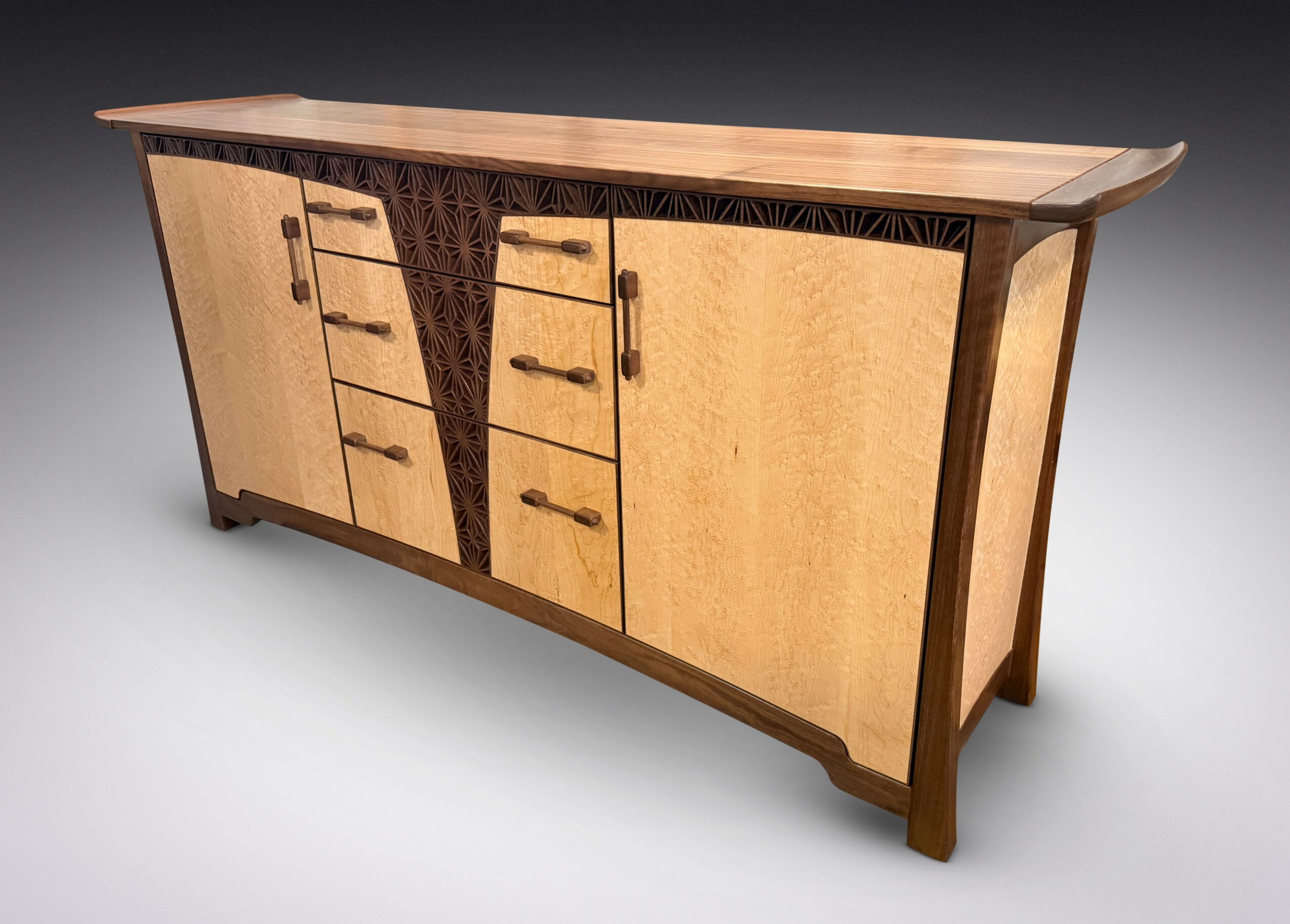 Wooden sideboard with multiple drawers and cabinet doors, featuring a curved top and decorative dark wood accents.