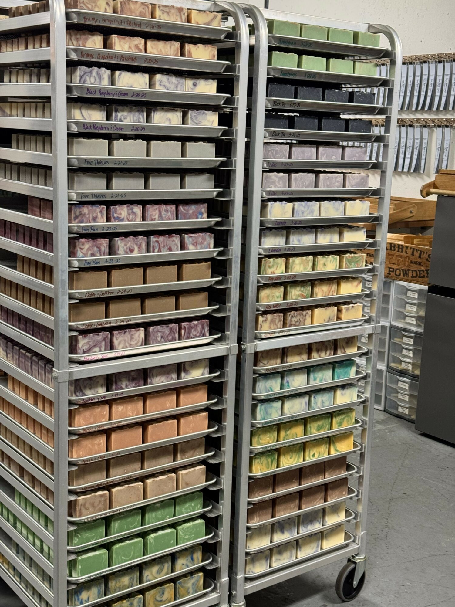 A metal cart with multiple rows of colorful soap bars arranged in a grid pattern.