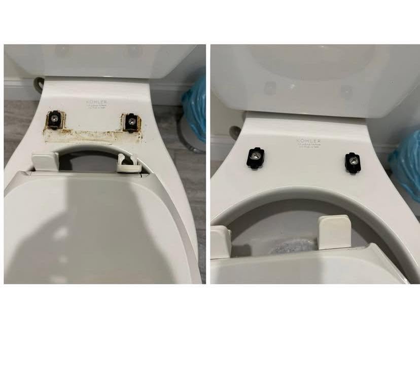 Toilet seat with missing lid, showing mounting hardware and rust stains, viewed from above.
