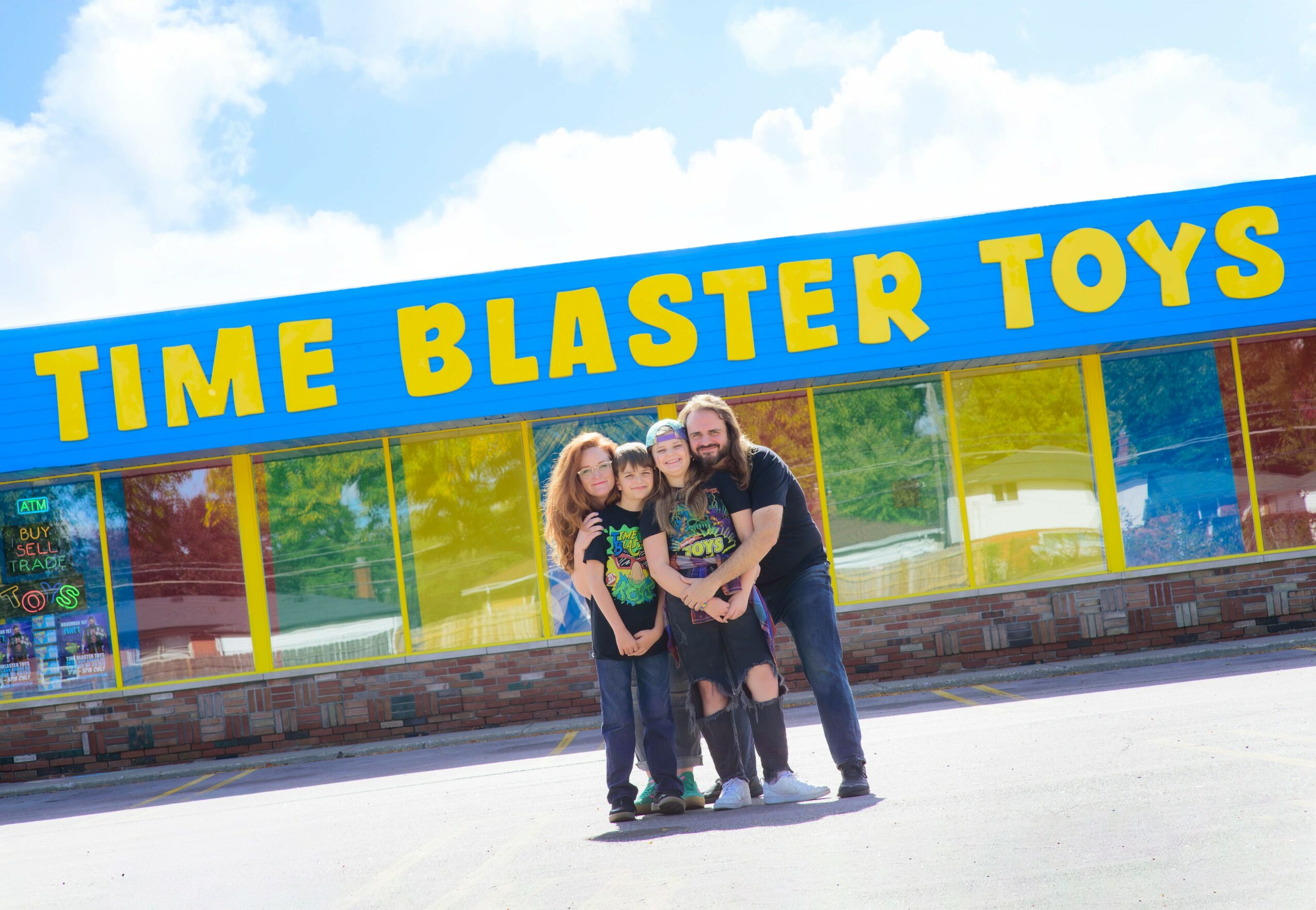 Three people standing outside a toy store with a sign reading 'TIME BLASTER TOYS'.
