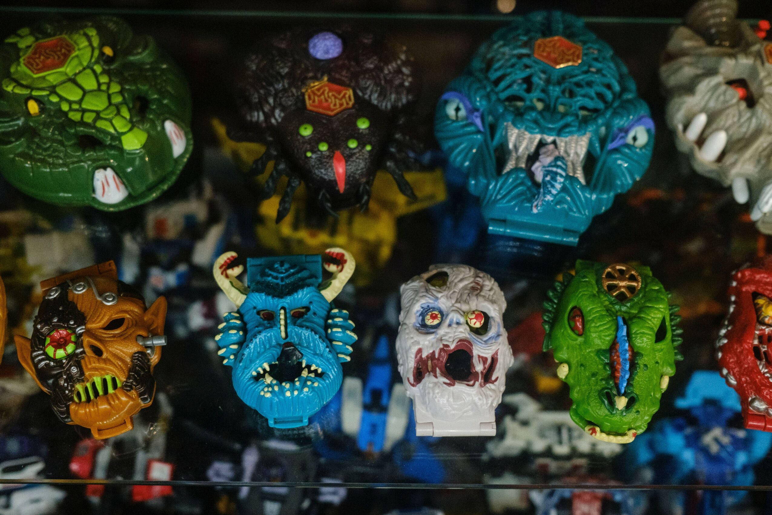 Collection of colorful, intricately designed animal figurines with various patterns and textures displayed together.