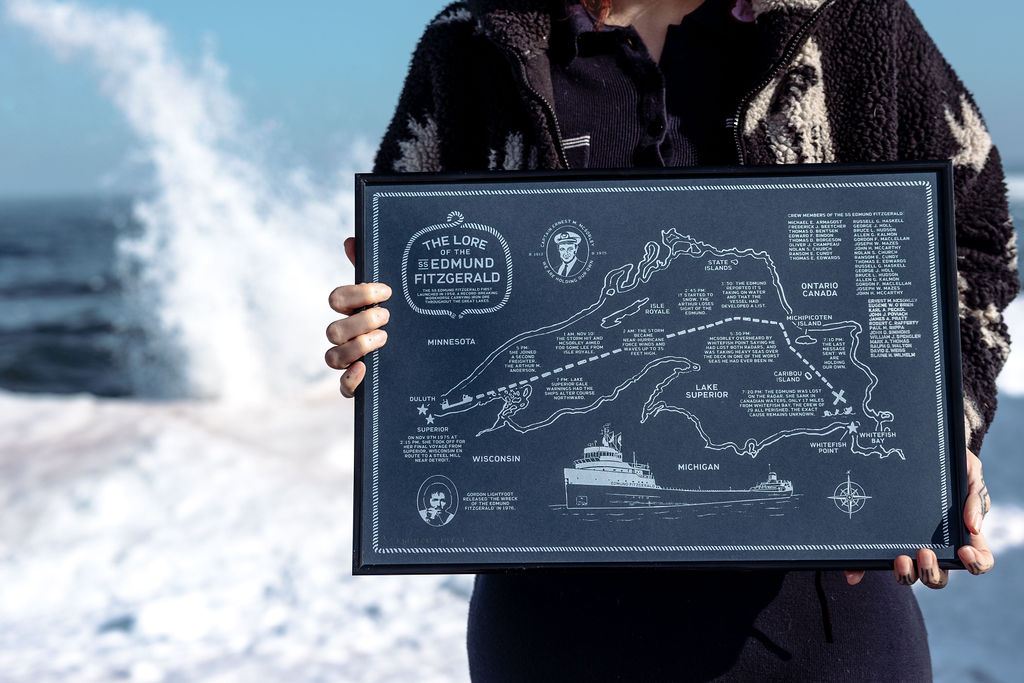 Person holding a map of Lake Ontario and surrounding areas with a boat in the background.
