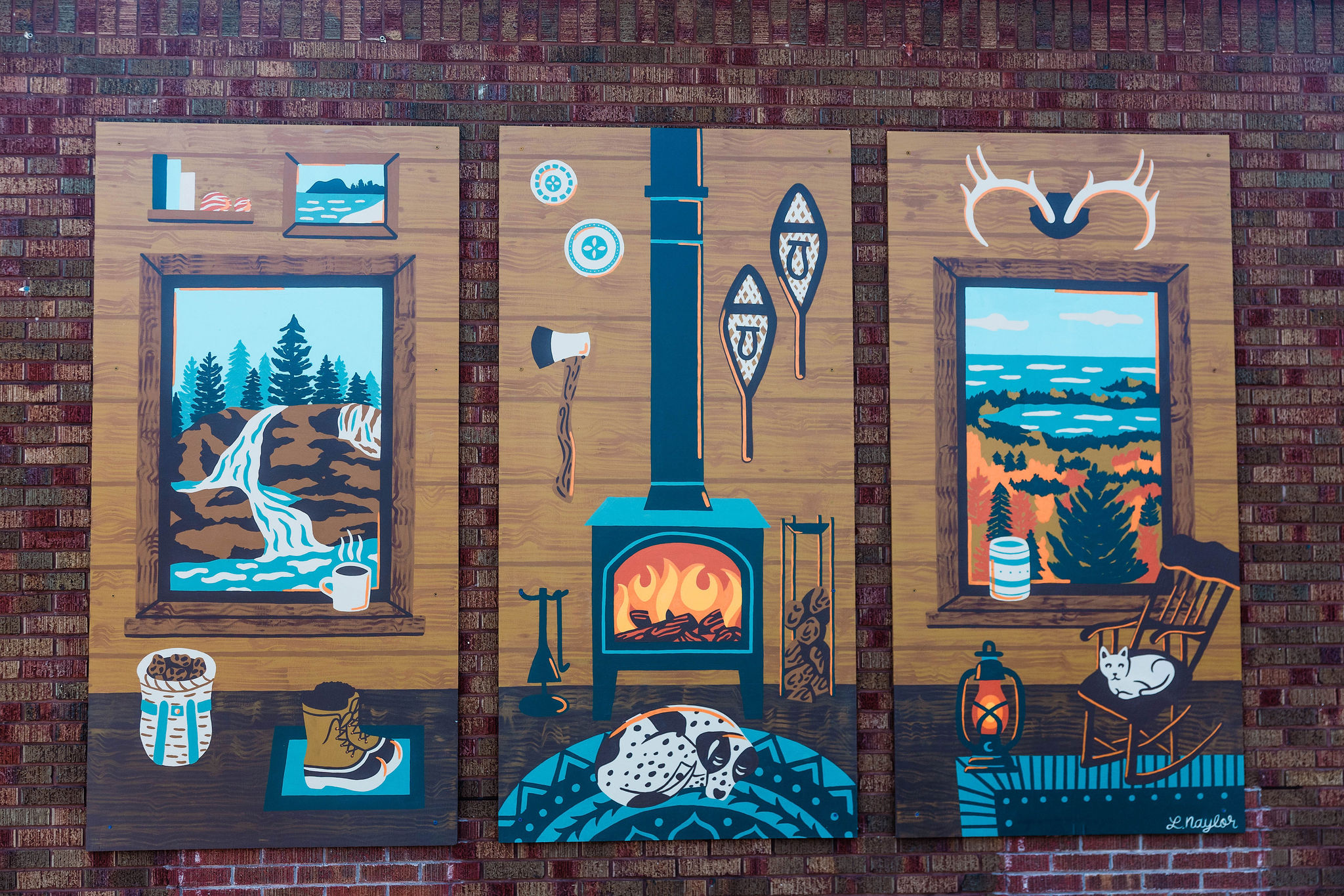 Three framed landscape paintings with a fireplace in the center, surrounded by outdoor scene decorations and objects.