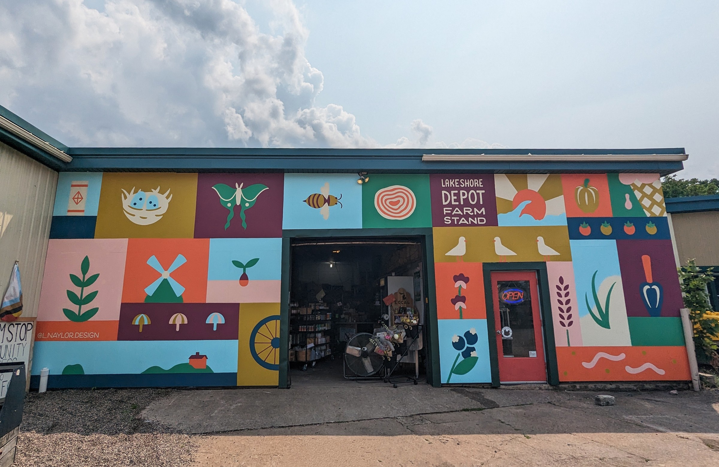 Storefront with colorful illustrations of plants, animals, and abstract shapes, and a sign reading 'Depot Farm'.