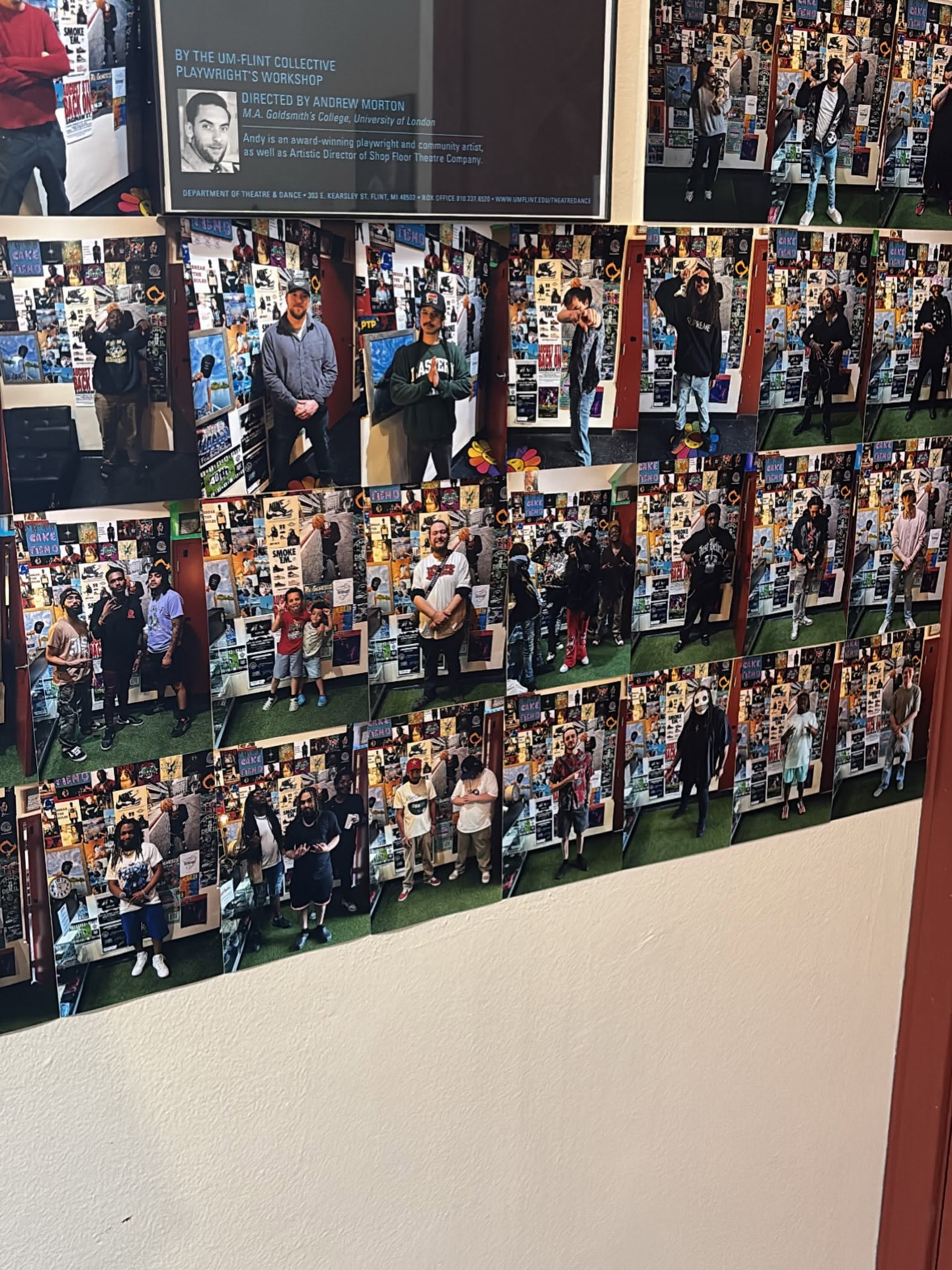 Display wall with multiple photos of people in a room, some standing and talking, with a bulletin board background.