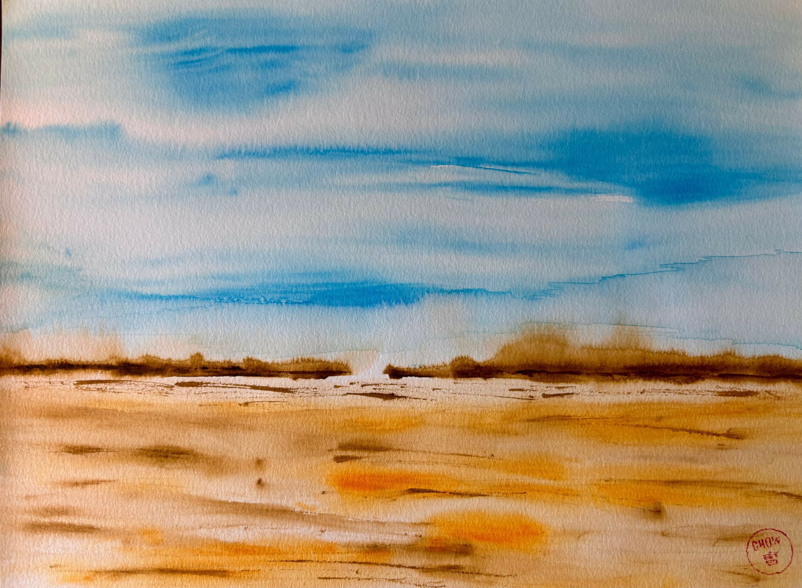 Landscape with blue sky and white clouds above a brown and orange desert or plain.
