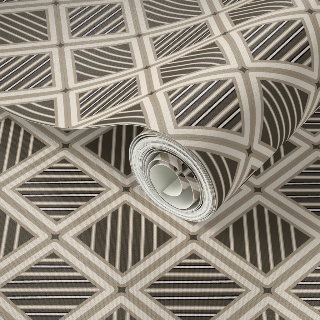 Rolled-up patterned wallpaper with geometric black, white, and gray design, on a flat surface.