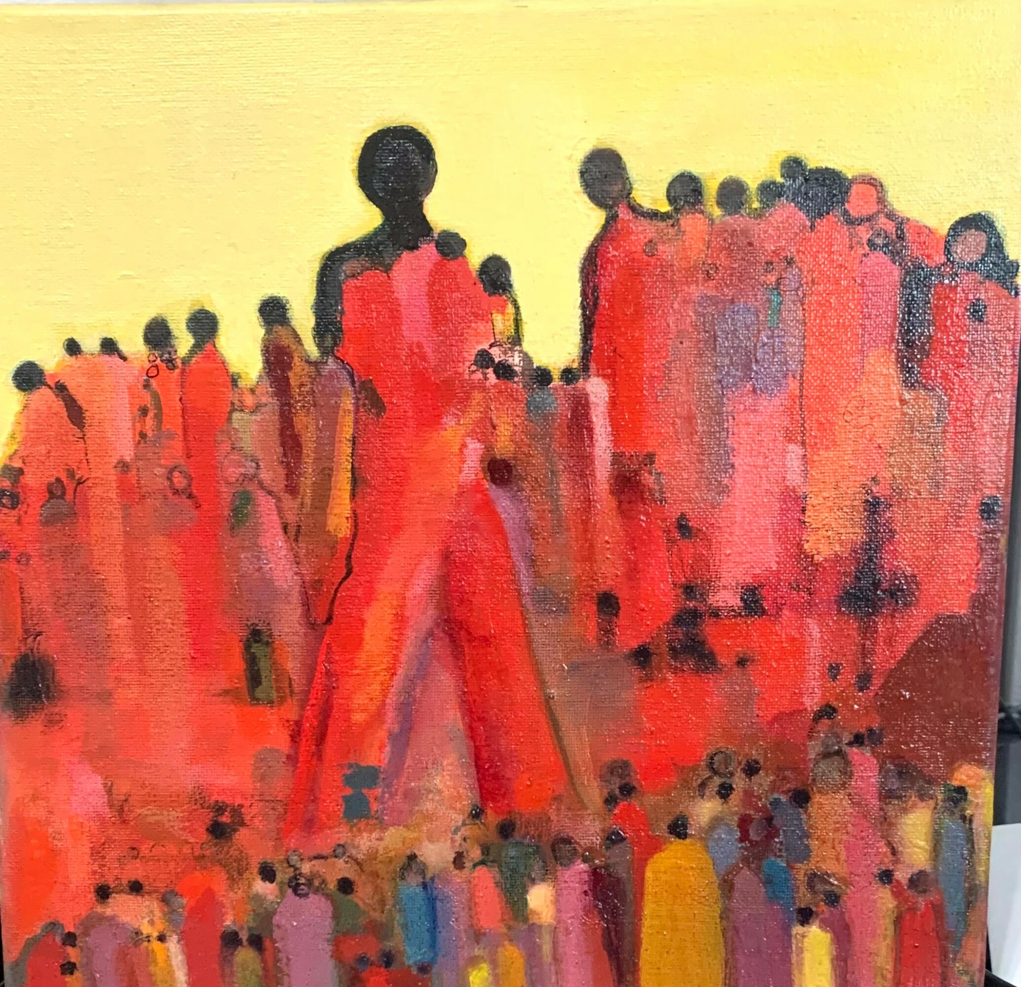 Abstract painting of people with dark heads and red, orange, and yellow clothing against a yellow background.